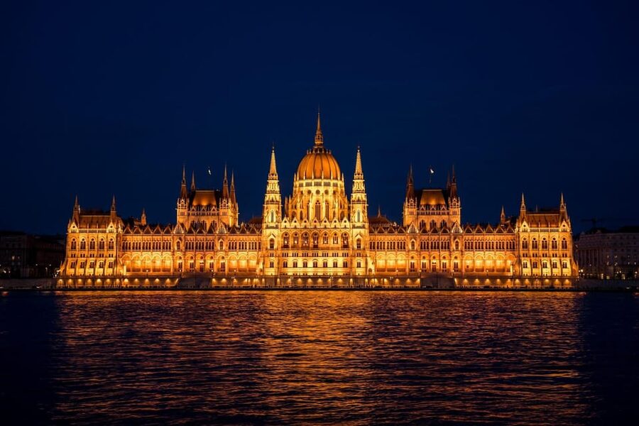 The Hungarian Parliament lit gold above the Danube at night